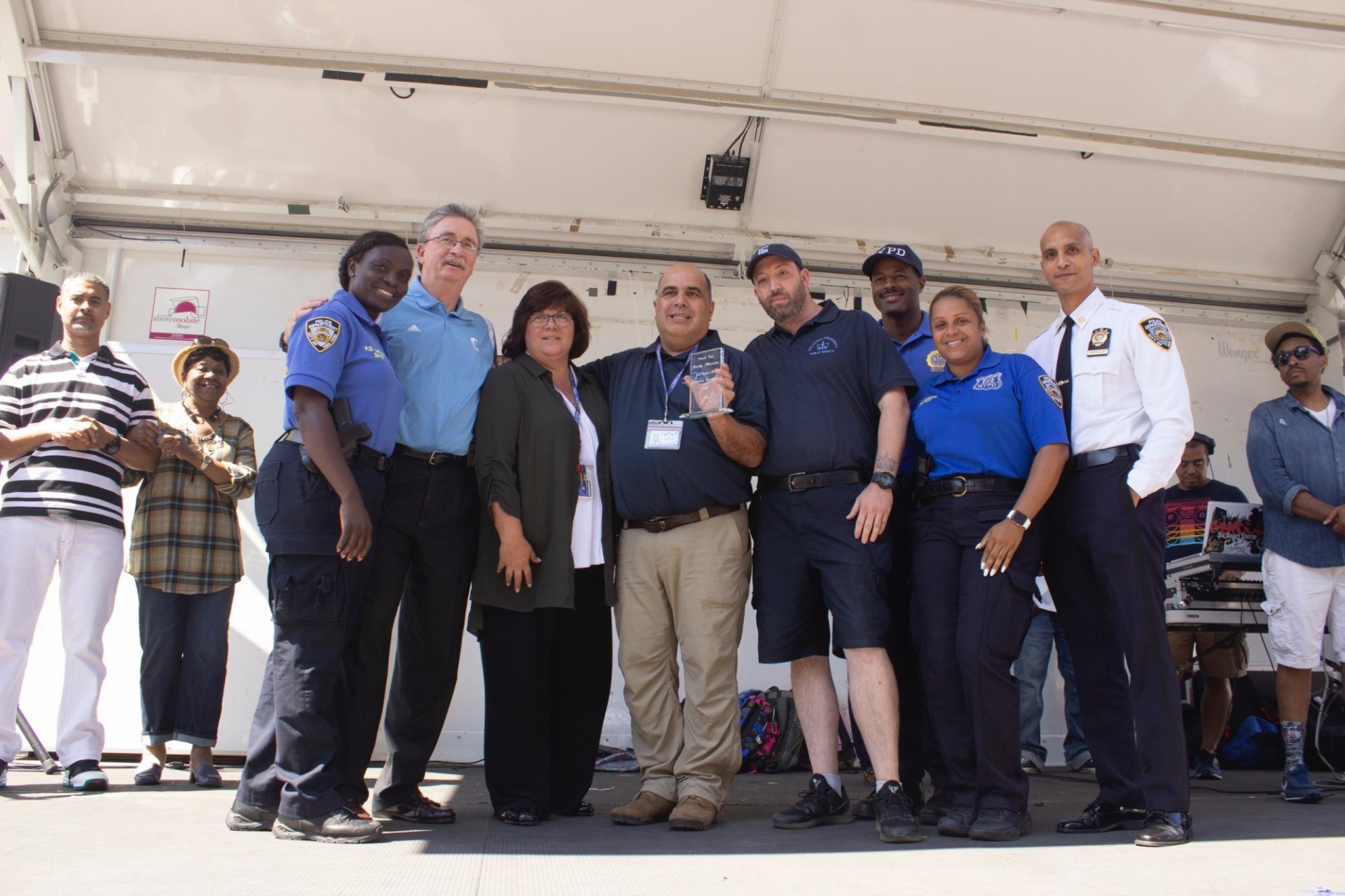NYPD Community Officer Kathleen Clifford (left) honored Assistant Director of Crime Prevention Ricky Morales (center) for his years of partnership between Columbia and the community.  
