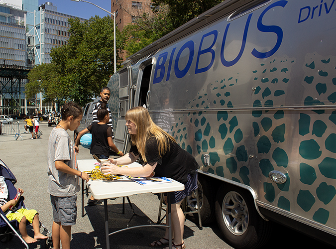 Columbia University BioBus Community Scientist Rosemary Puckett explains the variety of life in the Hudson River to a young Harlem resident.