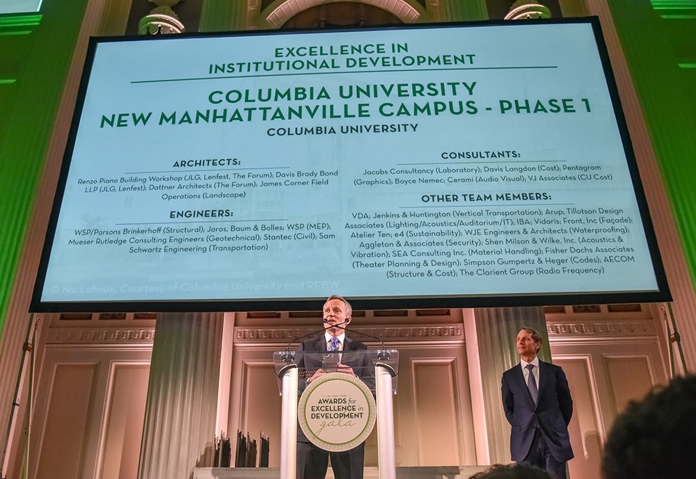 David Greenberg at a podium, accepting the ULI award with a white screen behind him detailing the design team 