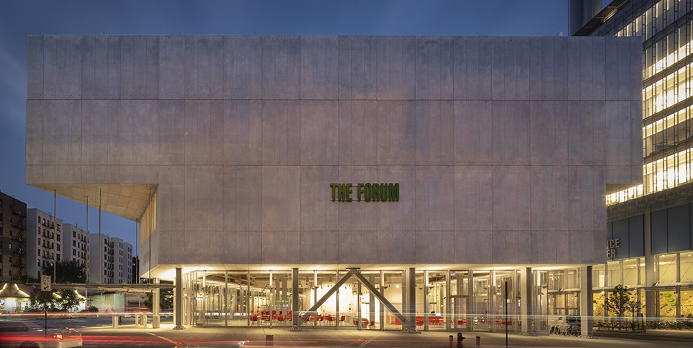 Side shot of The Forum during the evening, illuminated by interior building lights