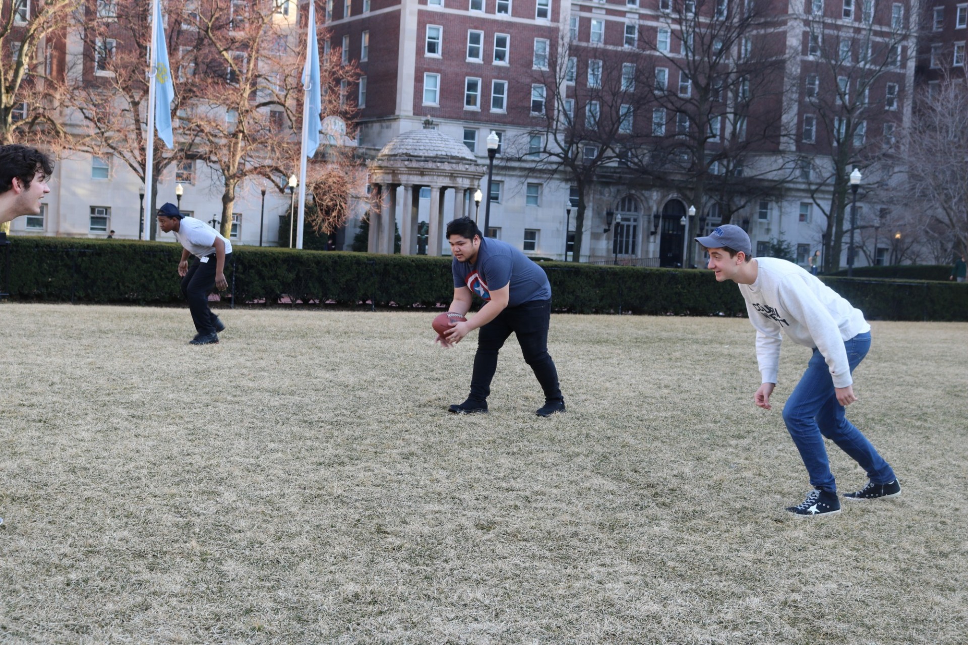 Students playing football on the South Field Lawn during January