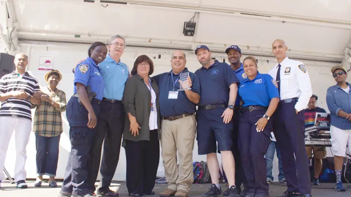 NYPD Community Officer Kathleen Clifford (left) honored Assistant Director of Crime Prevention Ricky Morales (center) for his years of partnership between Columbia and the community.  