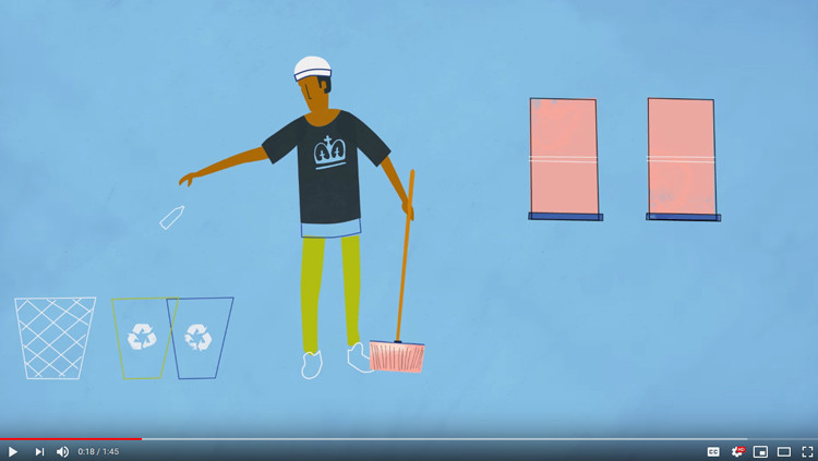 A screenshot of the Good Housekeeping video, with a still of an animated person throwing an empty bottle into the green, plastic recycling bin, with a broom in his other hand.