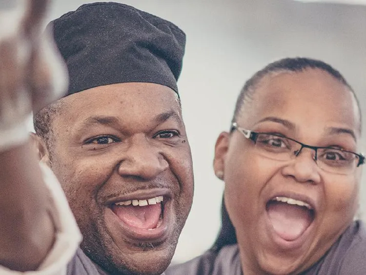 A man and woman smiling