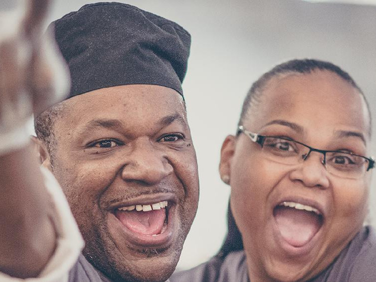 A man and woman smiling