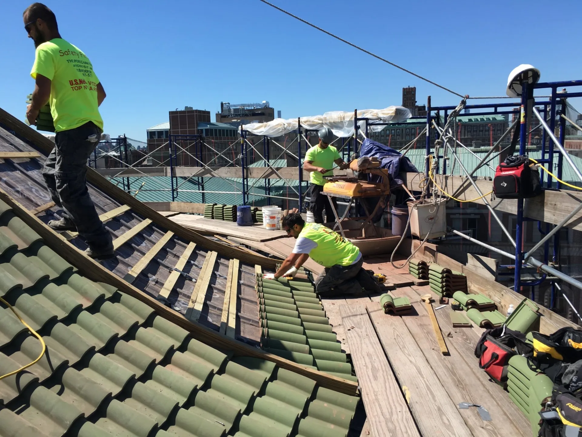 Contractors replacing tiles on the dome of St. Paul's Chapel.